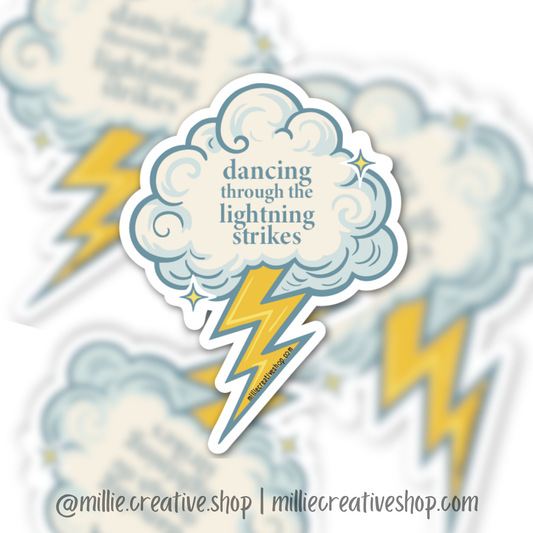 Sticker with cloud and lightning bolt design and text 'dancing through the lightning strikes' on a blurred background.